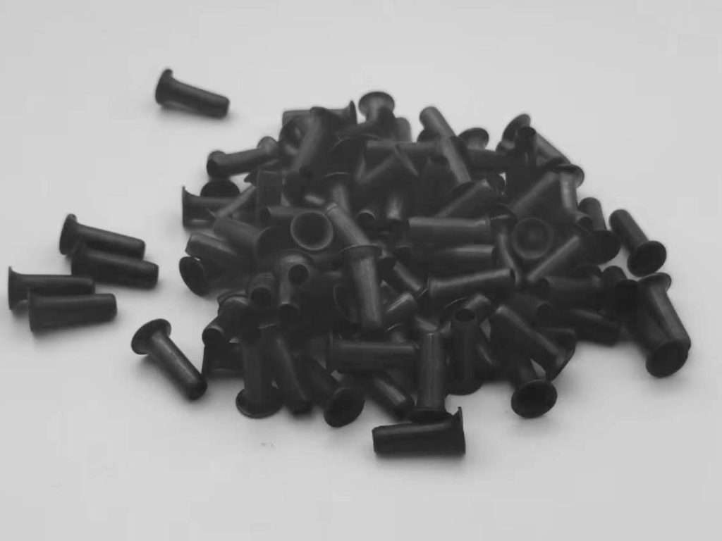 Black coated hollow rivets designed for seamless and invisible branch assembly in premium artificial Christmas trees.