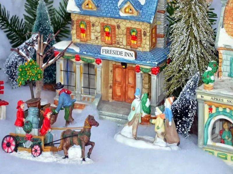 Commercial Christmas street display with snow-effect decoration, showing dry snow powder application for retail window scenes and large seasonal setups
