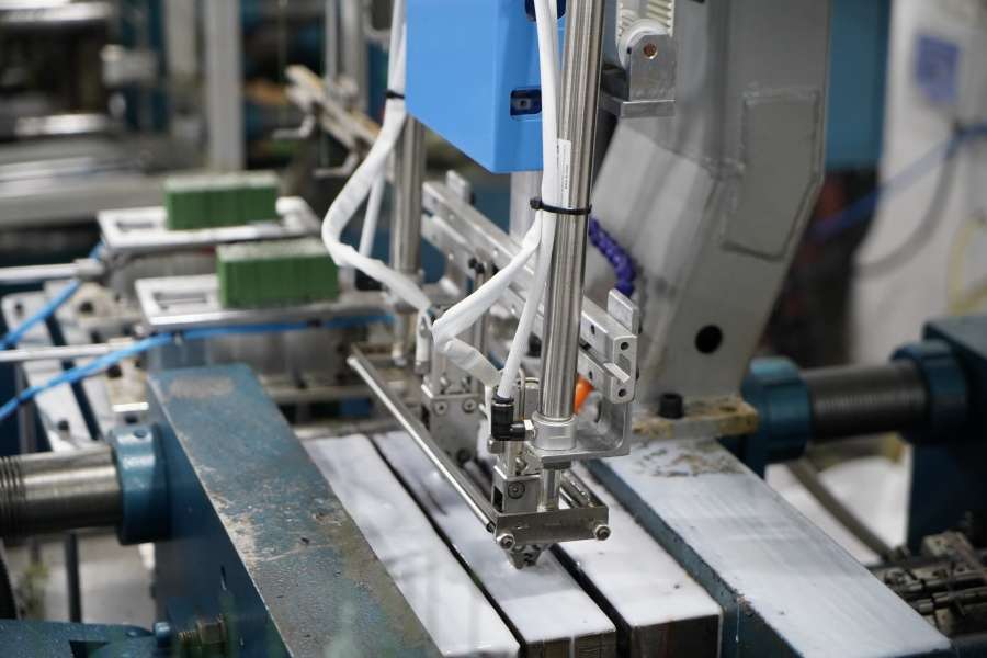 Industrial robotic arm performing precision manufacturing in Runyi Crafts factory
