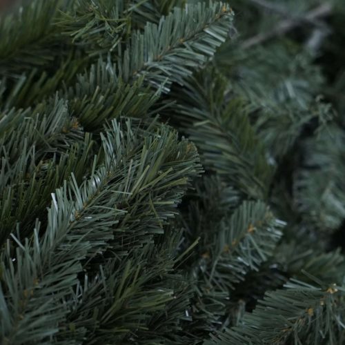 Close-up of realistic dark green PVC artificial Christmas tree needles, illustrating the finished quality achievable with high-grade raw material film for a manufacturer's buyer's guide.